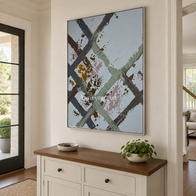 Weathered Cadence sage earth grid wall art with a silver frame in an entryway