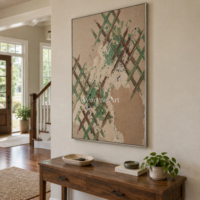 Earthen Trace sage earth grid wall art with a silver frame in an entryway