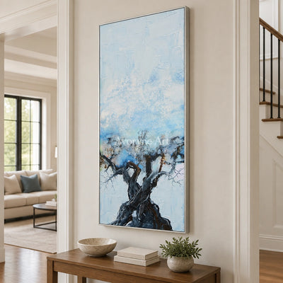 Blue Story snow branch wall art with a silver frame in an entryway
