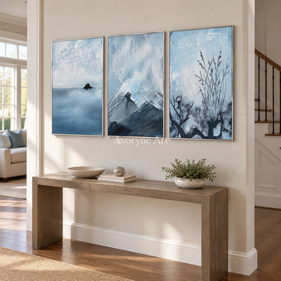 Deep Passage snow branch triptych with a silver frame in an entryway