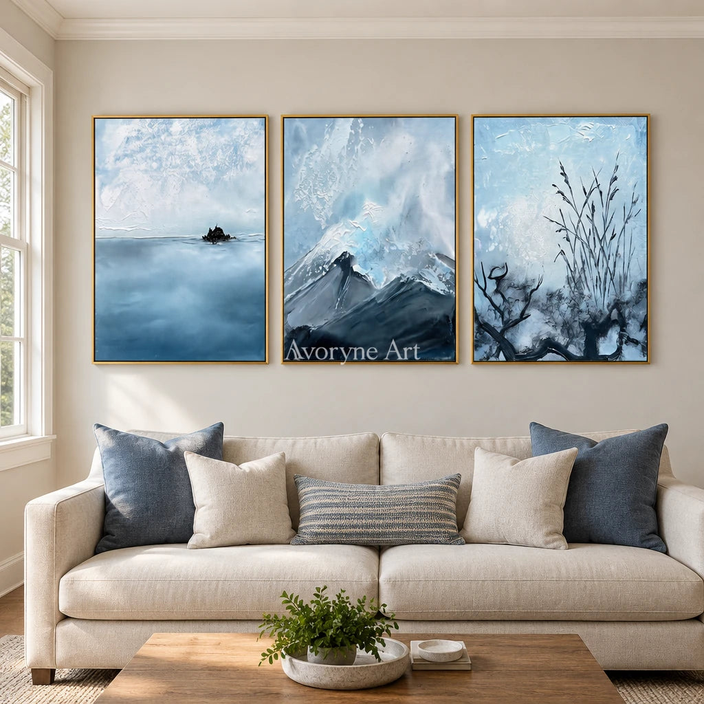 Deep Passage snow branch triptych with a gold frame hanging in a living room