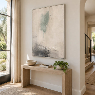Woven Passage soft neutral abstract wall art with a silver frame in an entryway