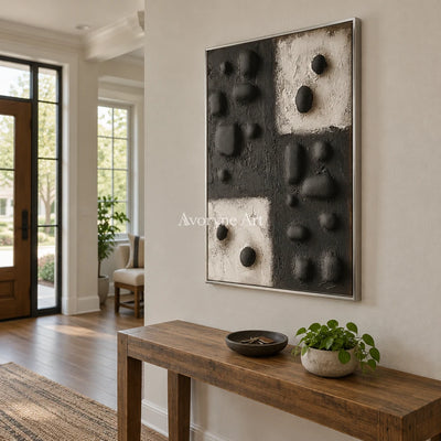 Muted Refrain stone dot relief wall art with a silver frame in an entryway