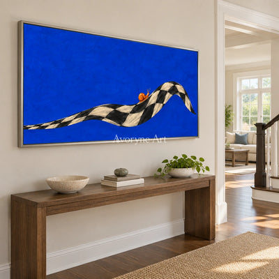 Still Prelude surreal scene wall art with a silver frame in an entryway