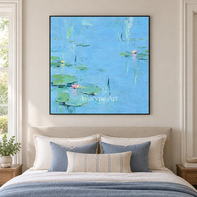Tender Gesture water lily wall art with a black frame above a bed in a bedroom