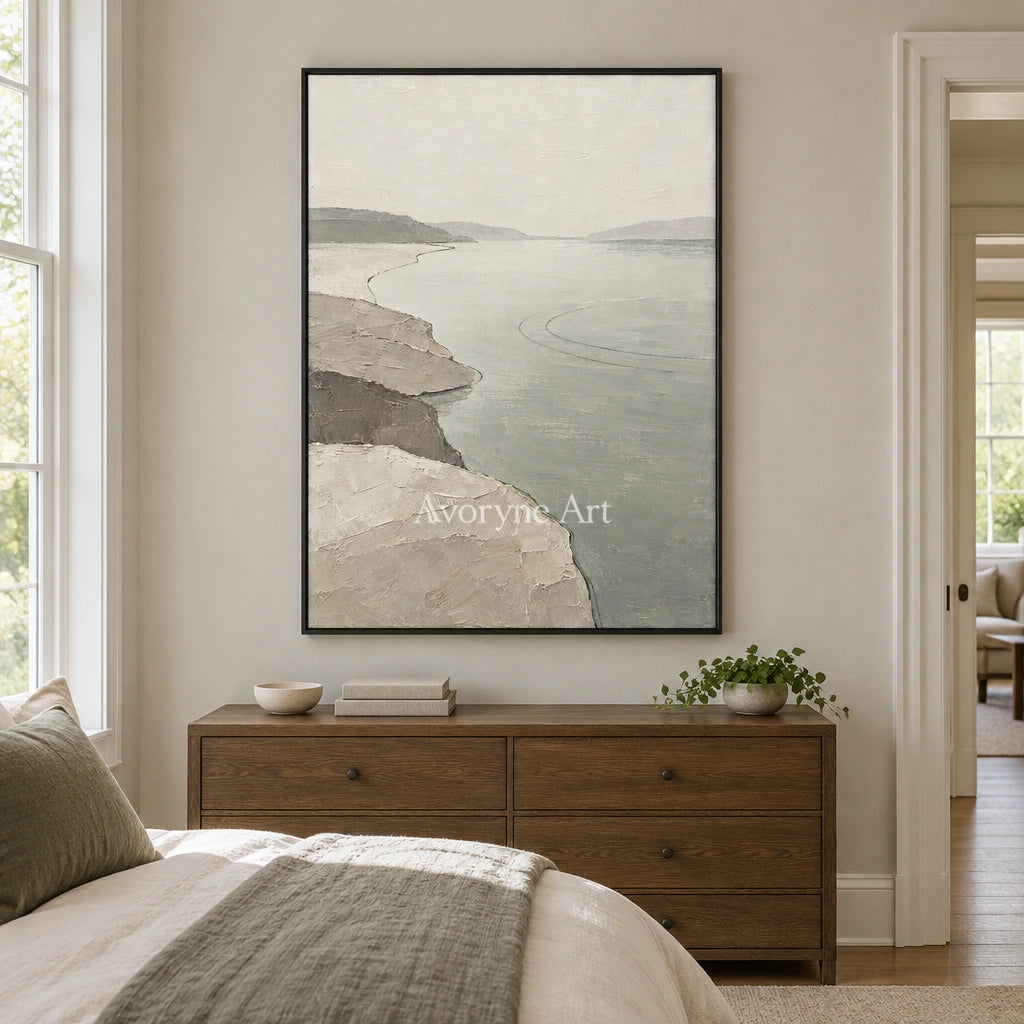 Tender Reverie waterside landscape wall art with a black frame above a bed in a bedroom