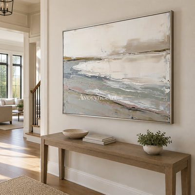 Bright Prelude waterside landscape wall art with a silver frame in an entryway