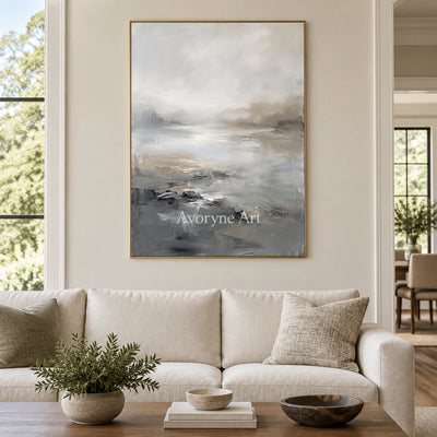 Winding Solace waterside landscape wall art with a gold frame hanging in a living room
