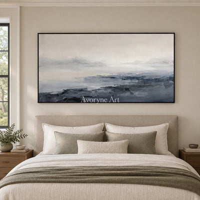 Winding Dialogue waterside landscape wall art with a black frame above a bed in a bedroom