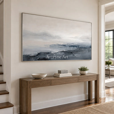 Winding Dialogue waterside landscape wall art with a silver frame in an entryway